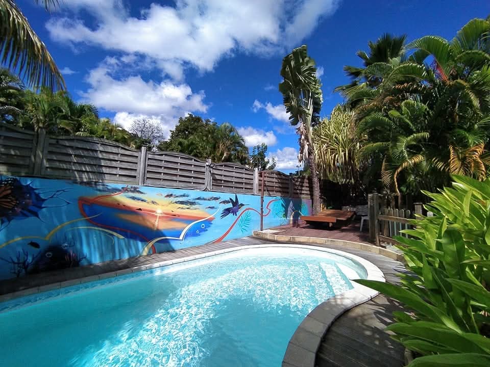 La piscine au sel, sa fresque de poissons et les palmiers